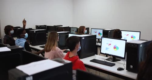 Young Multiracial Students Wearing Safety Face Masks Inside Computer Classroom at University Academi