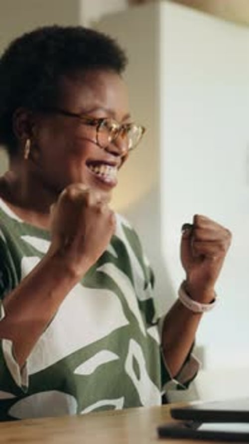 Excited Woman Working from Home on Laptop
