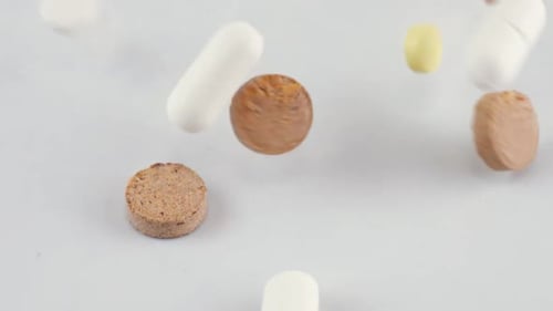 Falling tablets and pills. Medicine and healthy. Close up of capsules.