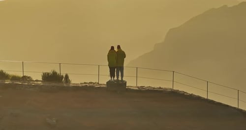 Couple Enjoys Mountain Vista During Golden Sunrise