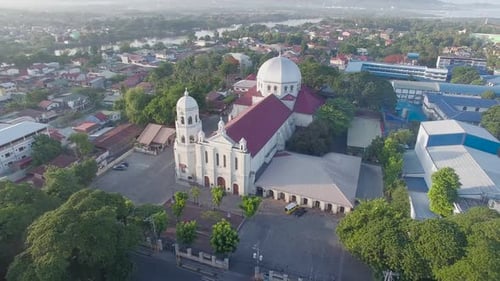 A glowing shiny majestic landscape drone view of a Basilica Church of the city having river and moun