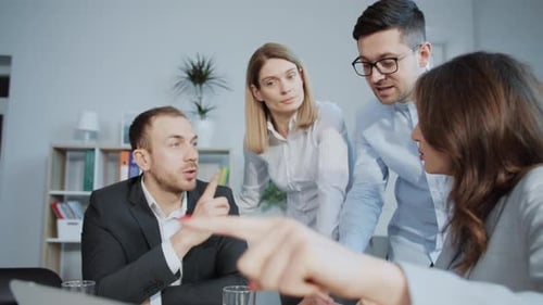 Team Collaboration: Colleagues Discussing Data in Office