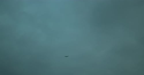 Mysterious object flying under an overcast sky, hinting at unidentified phenomena