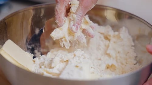 Women's Hands Mix Flour And Butter While Preparing Dough For Homemade Cookies