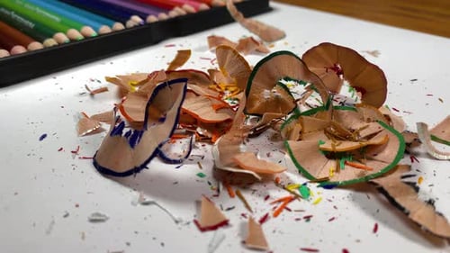 Colored Pencils and Shavings on White Table Close Up