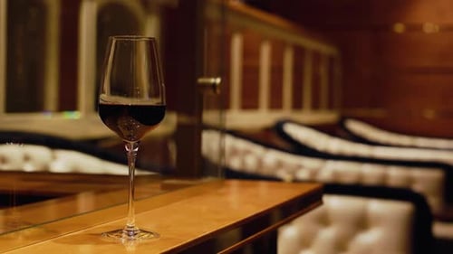 A Crafted Red Wine Glass in an Upscale Lounge Creates a Relaxing and Inviting Ambiance for Guests to