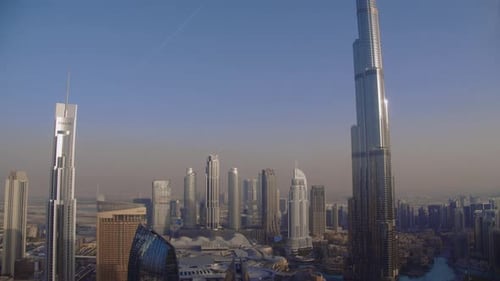Dubai Downtown skyline timelapse with towers with long shadows during sunrise panoramic view from th