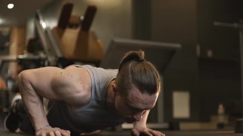 Strong Athlete Doing Push Up Exercise in Gym
