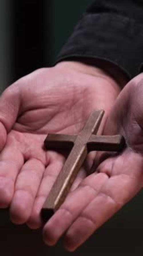 Hands Holding Wooden Christian Cross