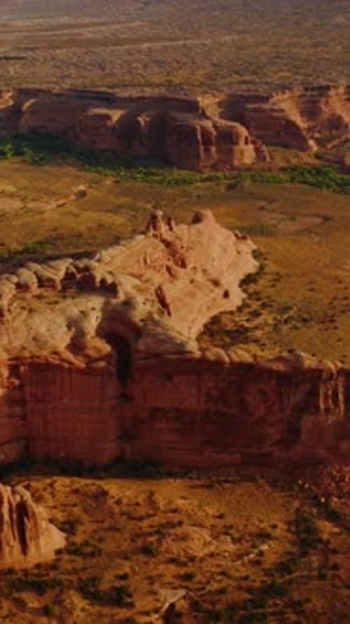 Arches canyons in Utah, USA. Amazing landscape of huge rocks in the rays of bright sun. Aerial view.