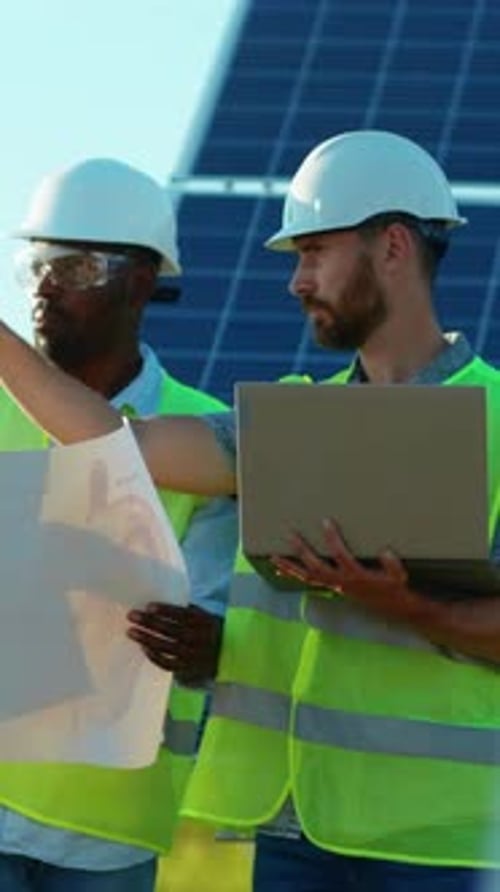 A Group of Engineers are Actively Collaborating on a Solar Panel Installation Project