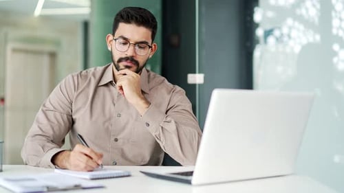 Young Adult Working at Computer in Office