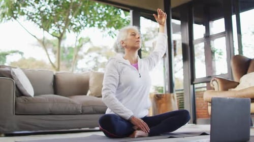 Senior Woman Does Yoga at Home