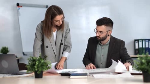Man and Woman Discussing Architectural Plans