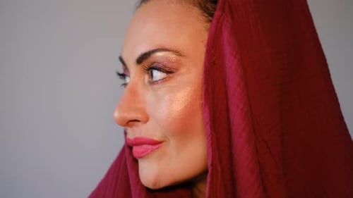 Beautiful Woman with Dramatic Makeup and a Red Scarf