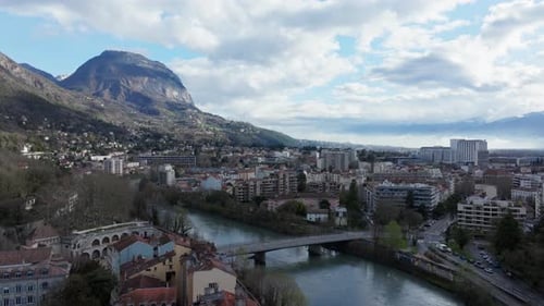 Aerial View of Grenoble City Center Showcasing the Isere River and Its Bridges and French Alps Under