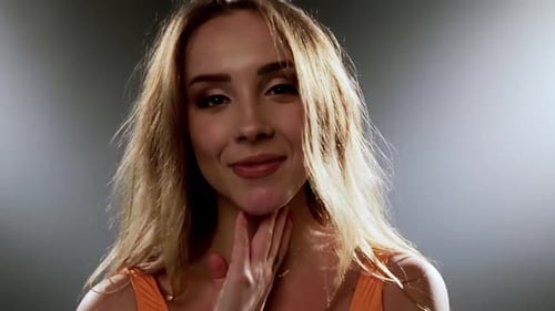 Young Woman Smiling and Posing in Studio