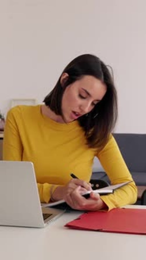 Woman Working at Desk Taking Notes