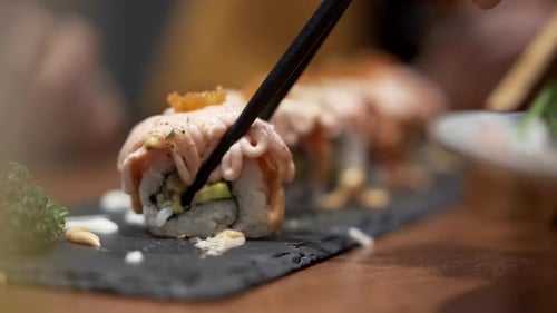 Close up a chopstick pick a sushi to grab