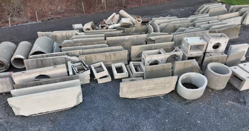 Prefab concrete pipe, drain, culvert. Broken used prefabricated highway barrier and civil engineerin