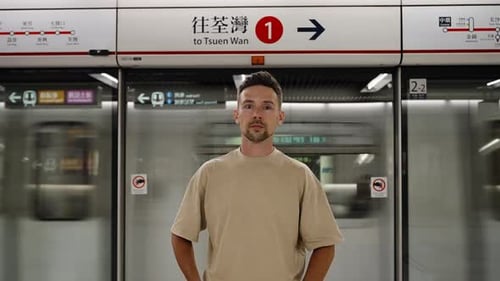 Man standing at modern subway platform in Hong Kong