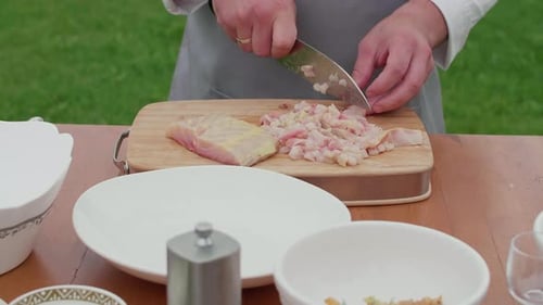 Chef Dicing Fish on Wooden Cutting Board