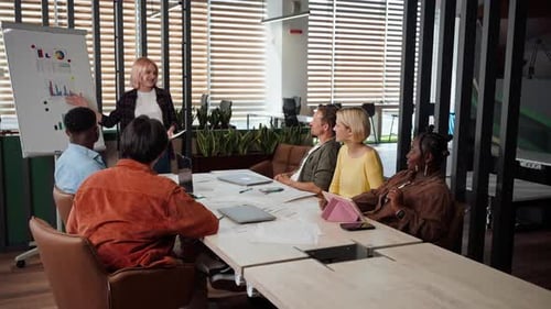 Diverse Team Applauds Presentation in Modern Office