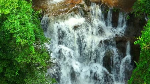 Tropical Waterfall Cascading Through Lush Greenery