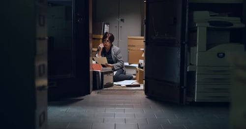 Professional woman working on files in dark lawyer office interior