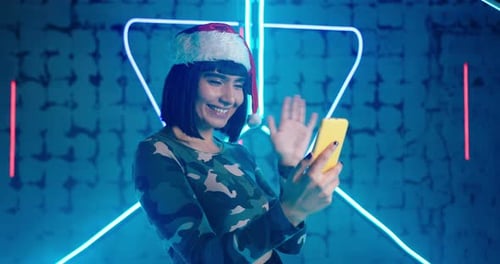 Lady Holds Smartphone Smiles Making Video Call in Nightclub