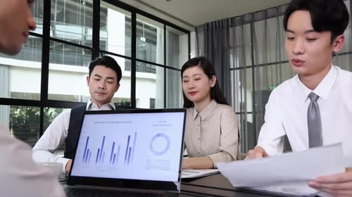 Business Team Meeting Discussing Data and Financial Performance