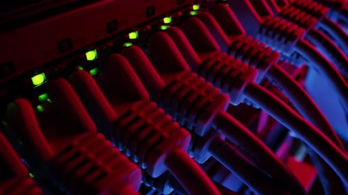 Server cables plugged in with glowing lights