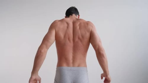 Muscular Man Stretching for Flexibility and Fitness