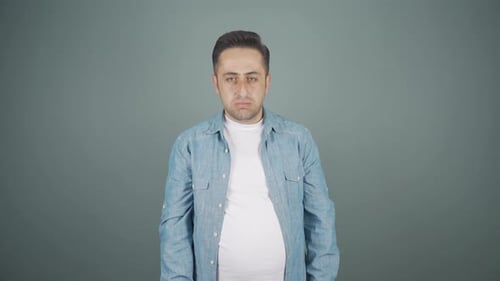 Man looking depressed at camera.