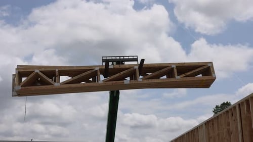 Construction Worker Assembling Wooden Framework Use Telehandler Crane Under Cloudy Sky at Building