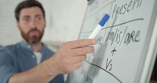 Männlicher Englischlehrer führt Online-Unterricht am White Board durch