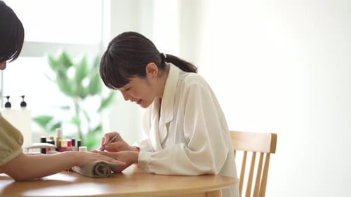 Woman Receiving a Manicure From an Esthetician