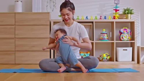 Mother and Baby Together Indoors on Yoga Mat
