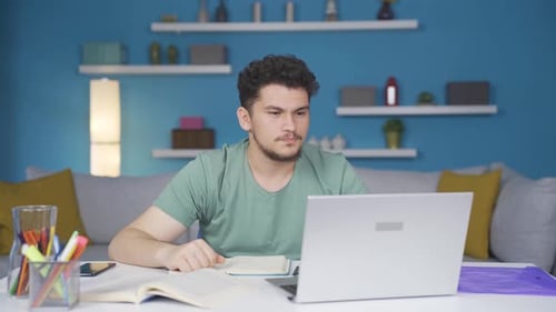 Young Adult Communicating on a Laptop at Home