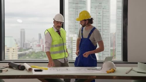 Construction Teamwork in an Office Overlooking City