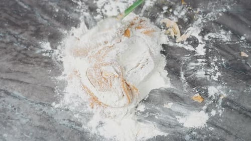 Top Down View of Dough Being Kneaded on Floured Tiled Table