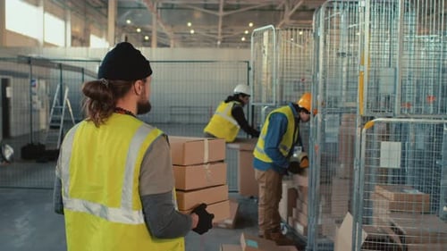 Warehouse Workers Sorting Packages in a Vast Warehouse