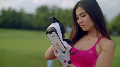 Woman Using VR Headset Controller in Outdoor Park