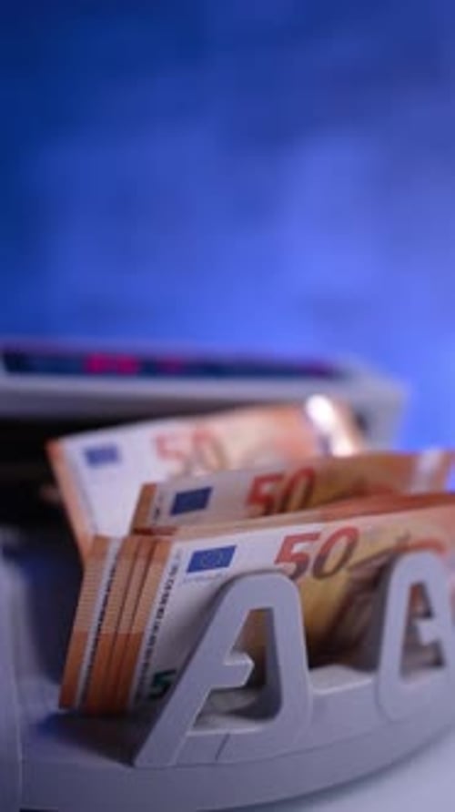 Modern cash counting machine counts fifty euro bills. Bank equipment calculates currency.