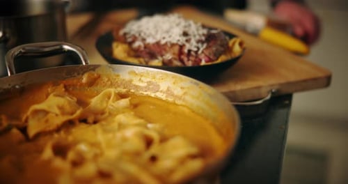 Person, chef and steak with pasta in kitchen for food, diet and meal preparation