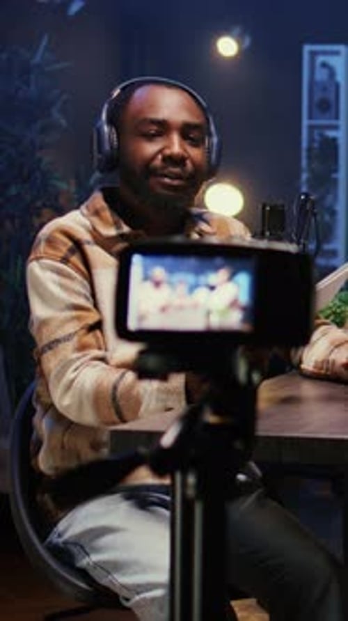 Young Adult Male Vlogging From Home at Night