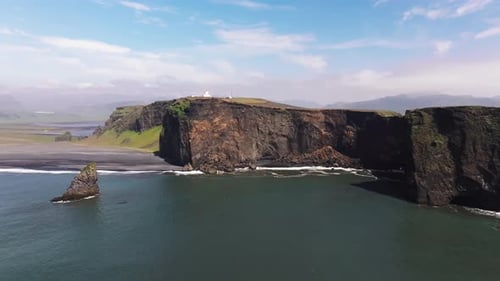 Aerial video over the cliffs of Dyrhulai, South Iceland