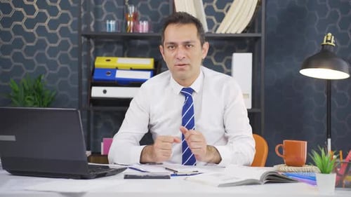 Professional Man Gesturing at Office Desk