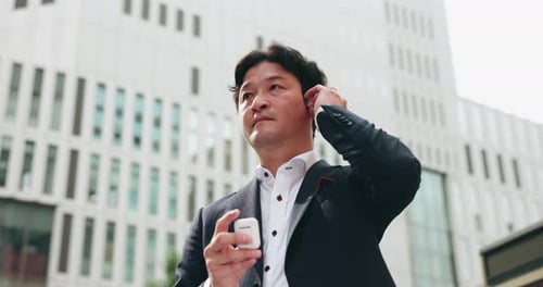 Asian, businessman and city with earphones for communication, business travel or music