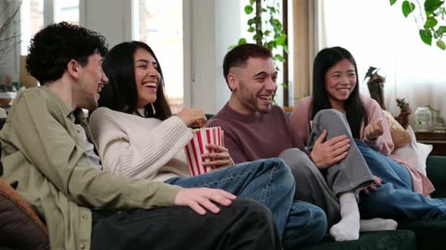 Group of diverse friends laughing watching comedy movie